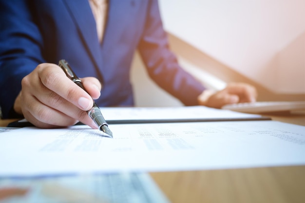 Midsection of businessman doing paperwork at desk in office