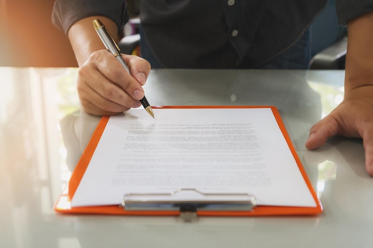 Fotografie midsection of businessman reading document on desk in office