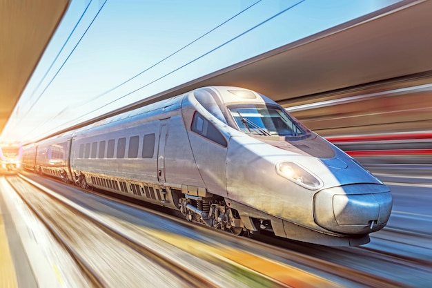 Modern high speed train on a clear day with motion blur at the city station