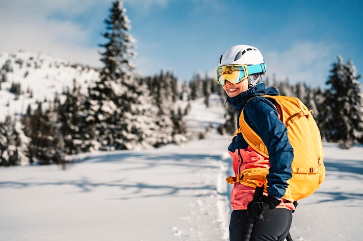 Fotografie mountaineer backcountry ski walking ski woman alpinist in the mountains ski touring in alpine landscape with snowy trees adventure winter sport freeride skiing