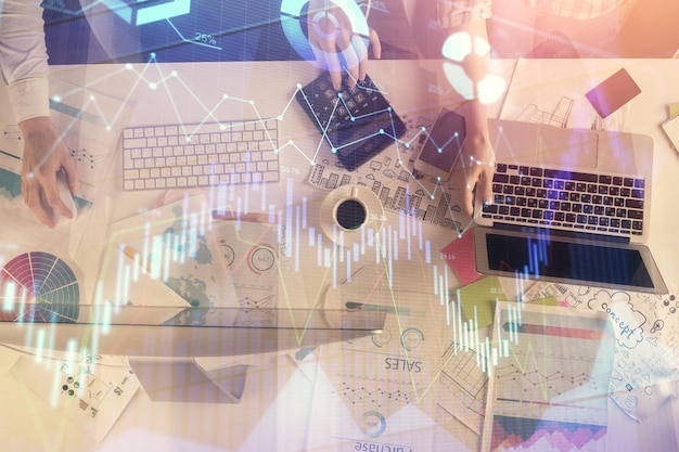 Multi exposure of man and woman working together and financial chart hologram Business concept Computer background