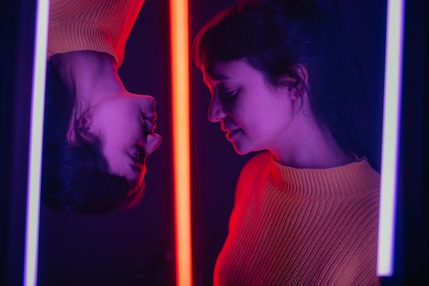 multiple image of young woman by illuminated lighting equipment