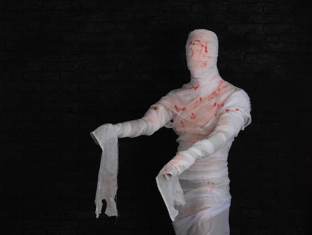 mummy in bandages on a black background