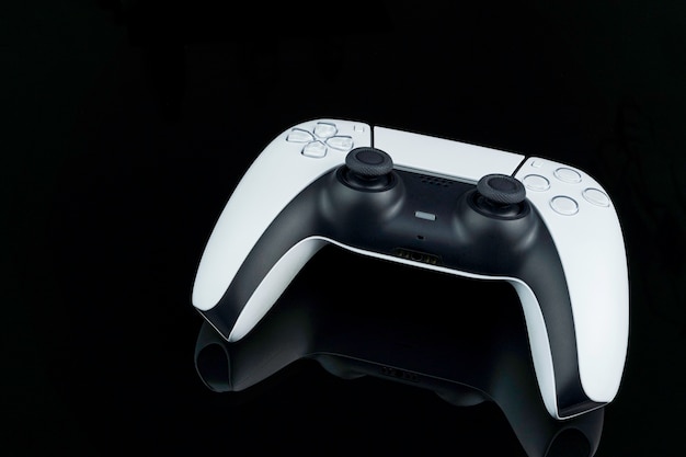 Next generation white game controller isolated on black background with reflection. Selective focus. Rio de Janeiro, RJ, Brazil. September 2021.