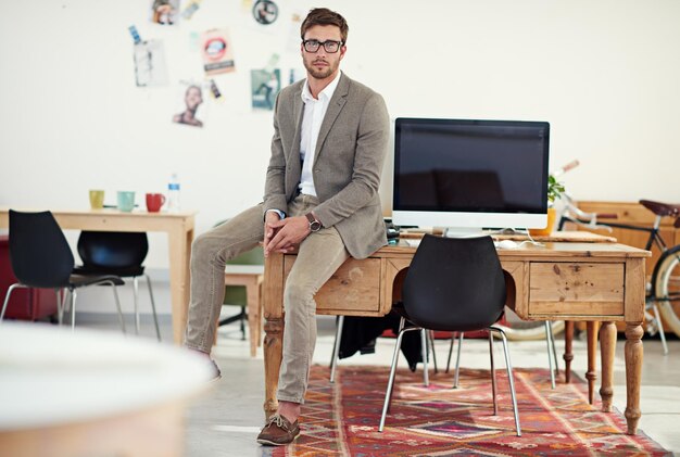 Office creative and portrait of business man with computer for SEO research website and internet Professional advertising agency and person at desk with confidence company pride and startup