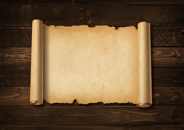 old mediaeval paper sheet. horizontal parchment scroll on a wood board background