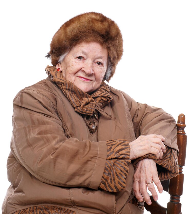 Fotografie old woman in winter outwear over white background