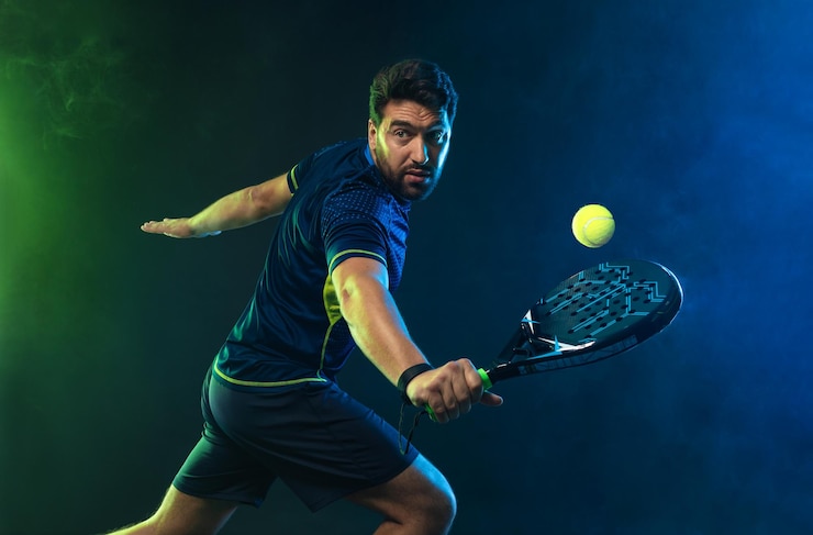 Fotografie padel tennis player with racket in hand paddle tenis on a blue background download in high resolution