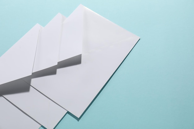 Paper envelopes on light blue background closeup Mockup for design