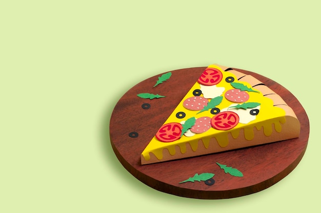 Paper pizza with sausage and olives