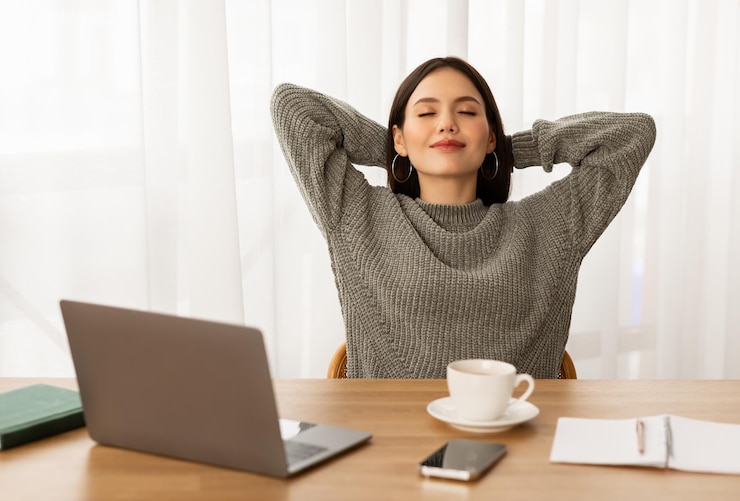 Fotografie peaceful young woman entrepreneur relaxing at home office