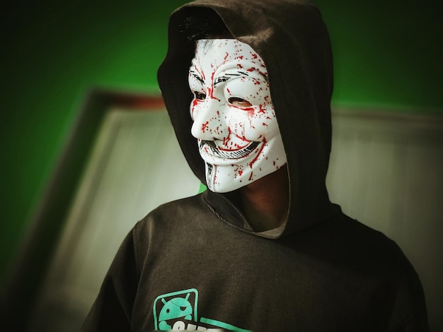 person wearing spooky mask at home