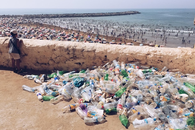 Plastic bottles by retaining wall against beach