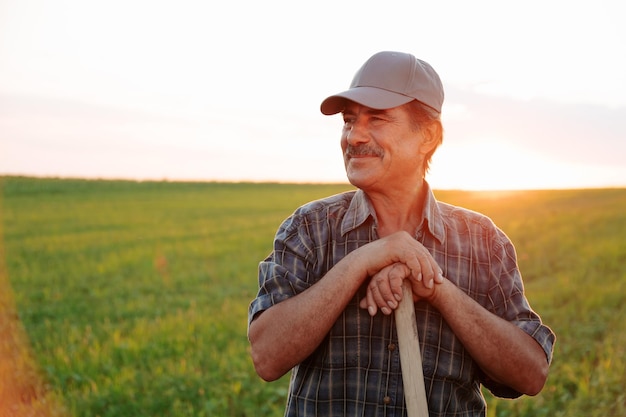 portrait of a cheerful male worker with mustache in agricultural farm sunlight