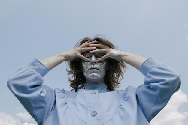 portrait of a young woman against sky