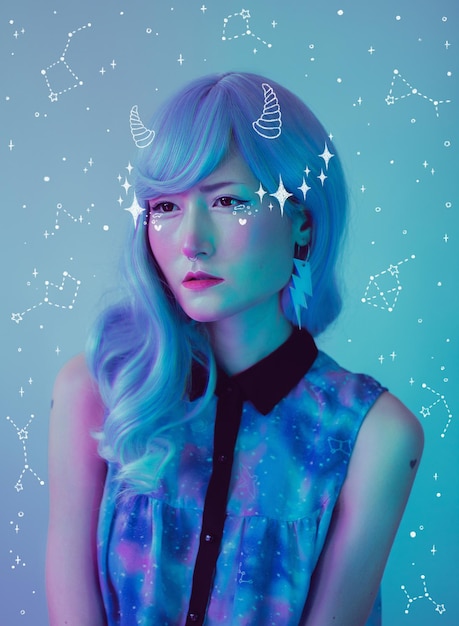 Portrait of beautiful young woman against blue background