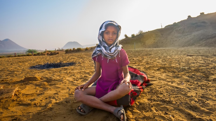 Fotografie portrait of boy wearing scarf while sitting on field