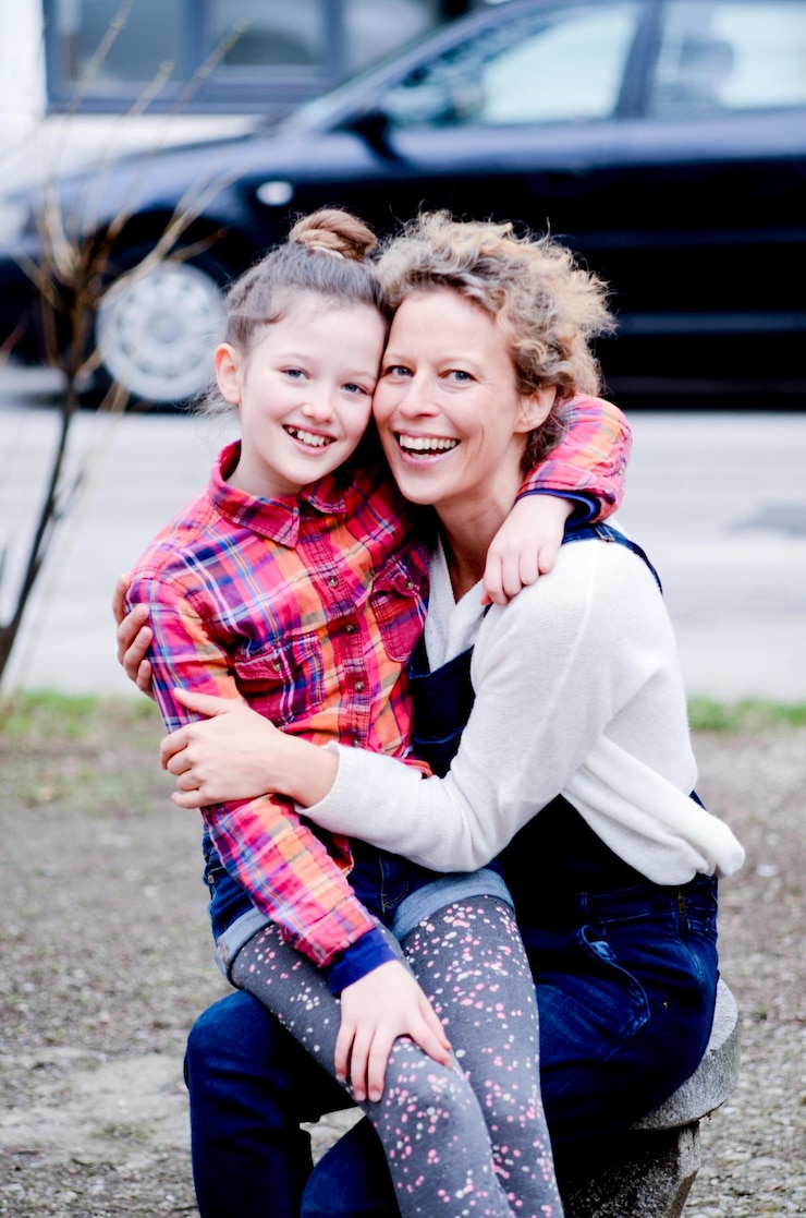 Fotografie portrait of cheerful girl embracing grandmother on footpath
