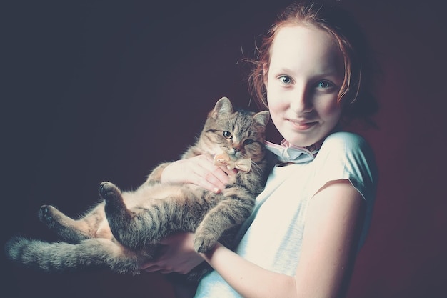 portrait of girl holding cat