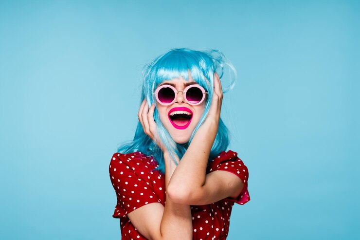 Fotografie portrait of woman wearing sunglasses against blue background