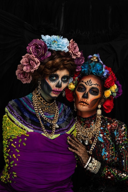 Portrait of women with spooky make-up wearing flowers