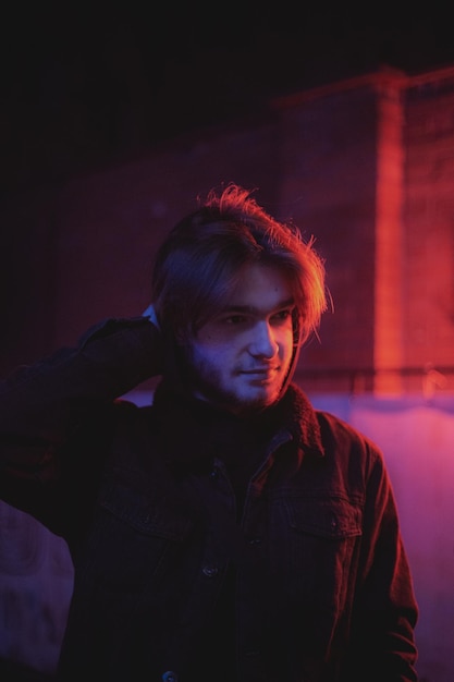 portrait of young man standing against wall