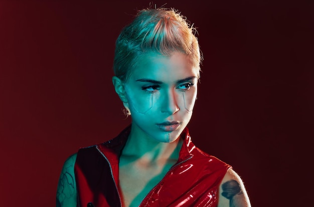 portrait of young woman against black background