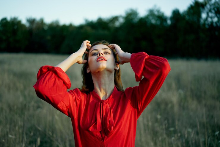 Fotografie portrait of young woman with arms outstretched standing on field
