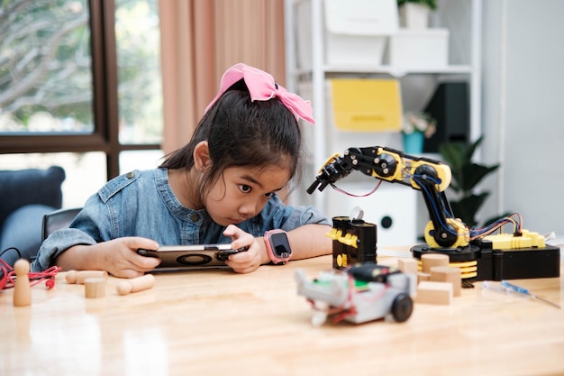 Primary School Girl Using App to Control Car in STEM Class