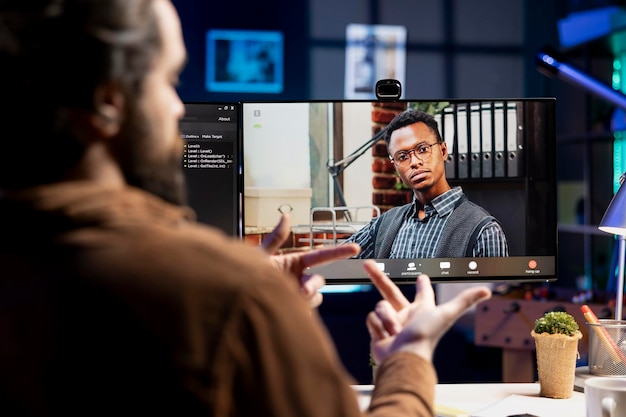 Programmer checking code with colleague in online teleconference