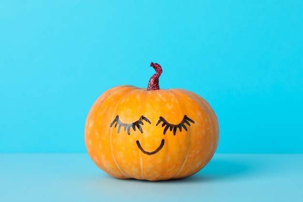 pumpkin with smile on blue, space for text