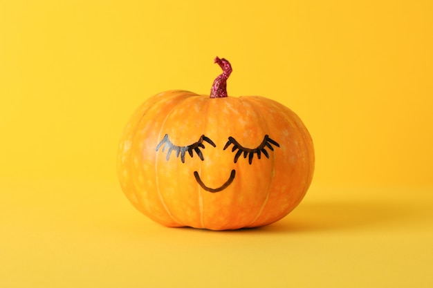 pumpkin with smile on yellow, space for text
