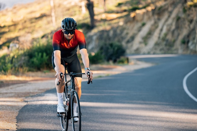 rear view of man riding bicycle on road
