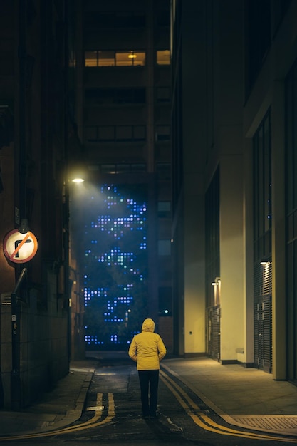 rear view of man walking in tunnel