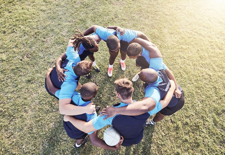 Fotografie rugby men and huddle of team with fitness motivation and pride in competitive game collaboration sports and teamwork diverse players ready for match workout or tournament above field at club