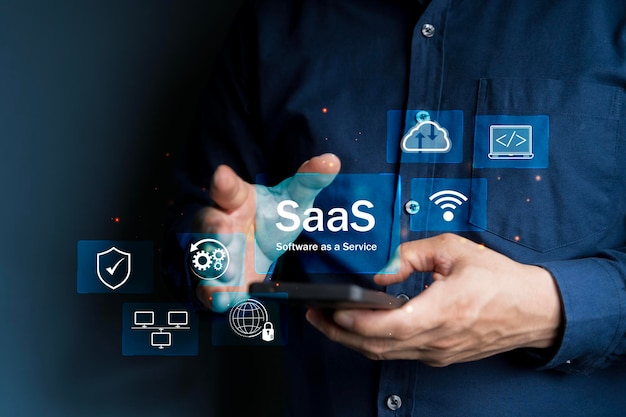 SaaS Concept Software as a Service A man types smartphone with digital icons representing various