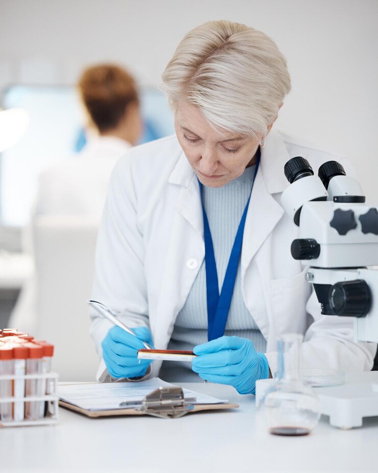 Fotografie science woman blood test and medical analysis in laboratory for scientist investigation or research person writing dna results sample or study in lab for biotechnology innovation or development