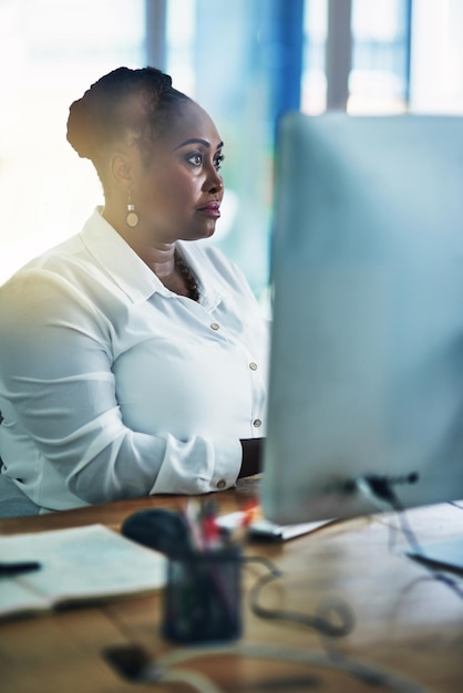 Serious business and black woman on computer in office for research reading email and typing proposal feedback African female person and secretary on pc for admin tasks schedule and appointments