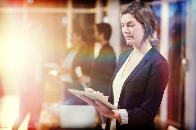 Side view of businesswoman using digital tablet