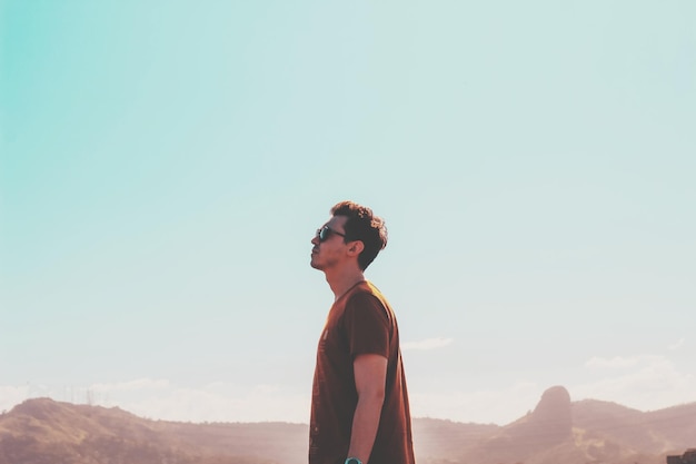 side view of man standing against sky