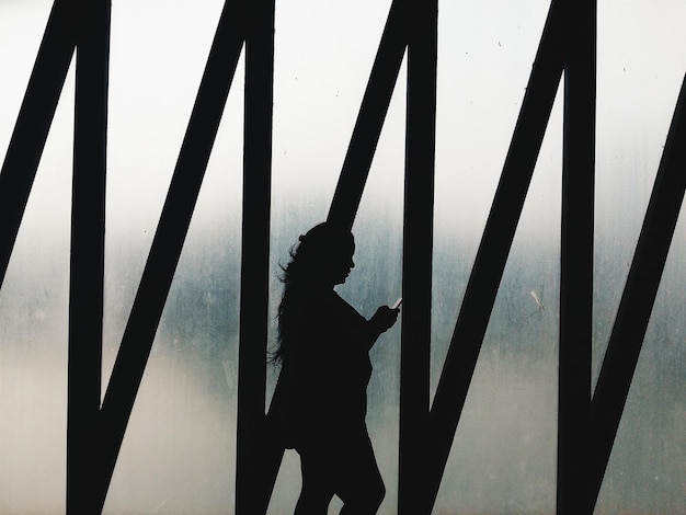 silhouette woman walking against frosted glass