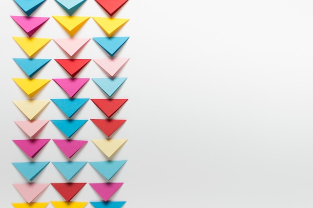 simple paper background with tree rows of paper folded triangles. photo with copy blank space.