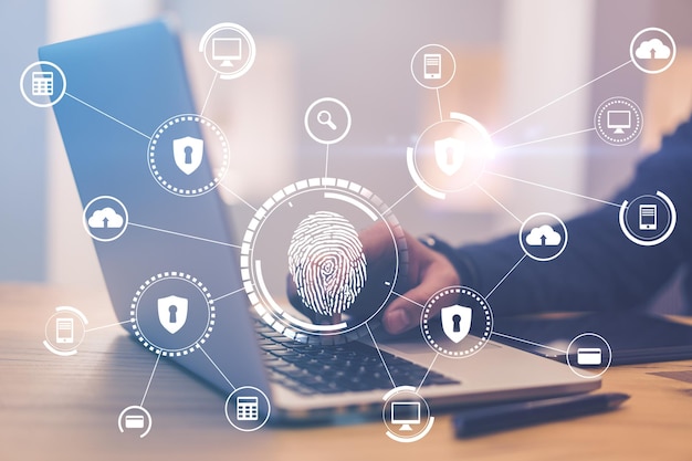 Smart technologies and biometrics concept with digital fingerprint and protection icons at laptop wih man hand background