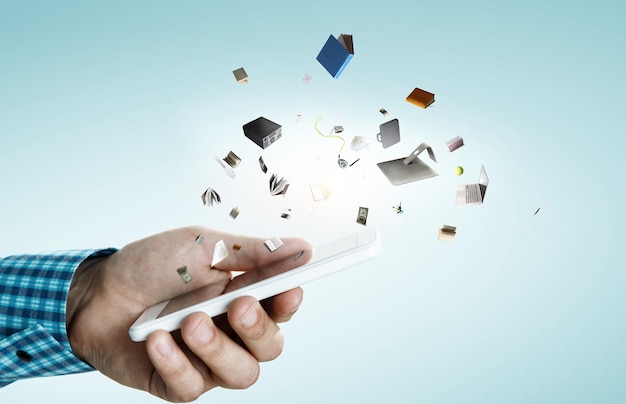 smartphone and books. e-reader concept. mixed media