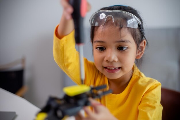 stem education concept asian students learn at home by coding robot arms in stem mathematics engineering science technology computer code in robotics for kids concepts