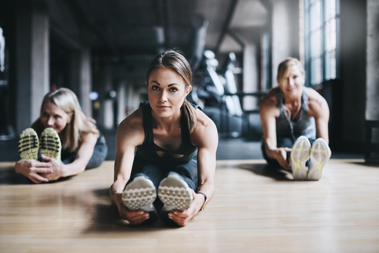 Fotografie stretching fitness and portrait of woman in gym for exercise training and warm up for mobility sports personal trainer and people for wellness health and flexibility for performance and strength