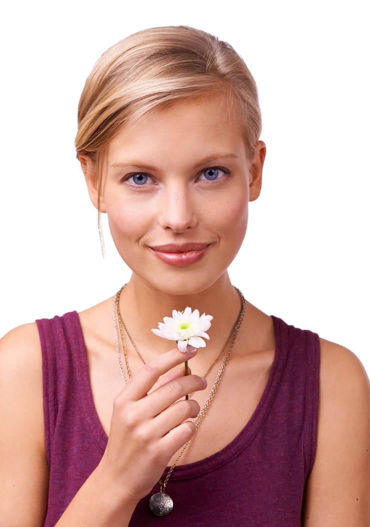 Fotografie studio woman and portrait of daisy by white background and scent of perfume of natural botanicals model face and creative inspiration with flower for stress relief and wellness with floral plant