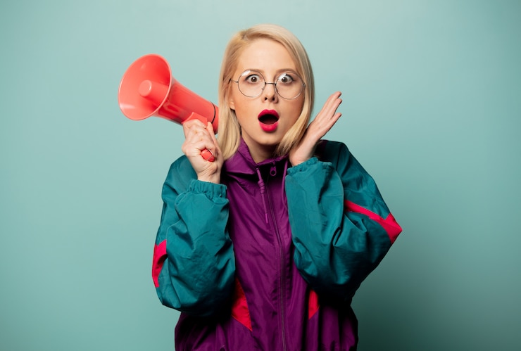 Fotografie style blonde woman in glasses with loudspeaker