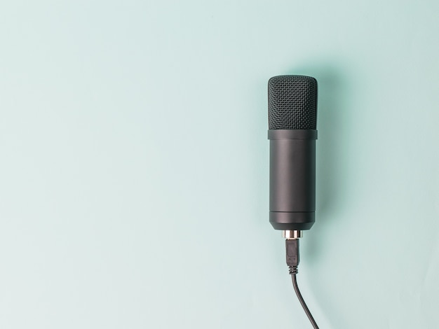 Stylish condenser microphone on blue