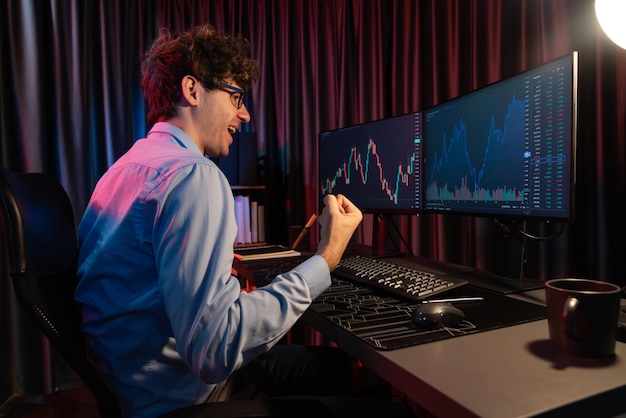 successful trader raising fist up with highest profit market stock gusher